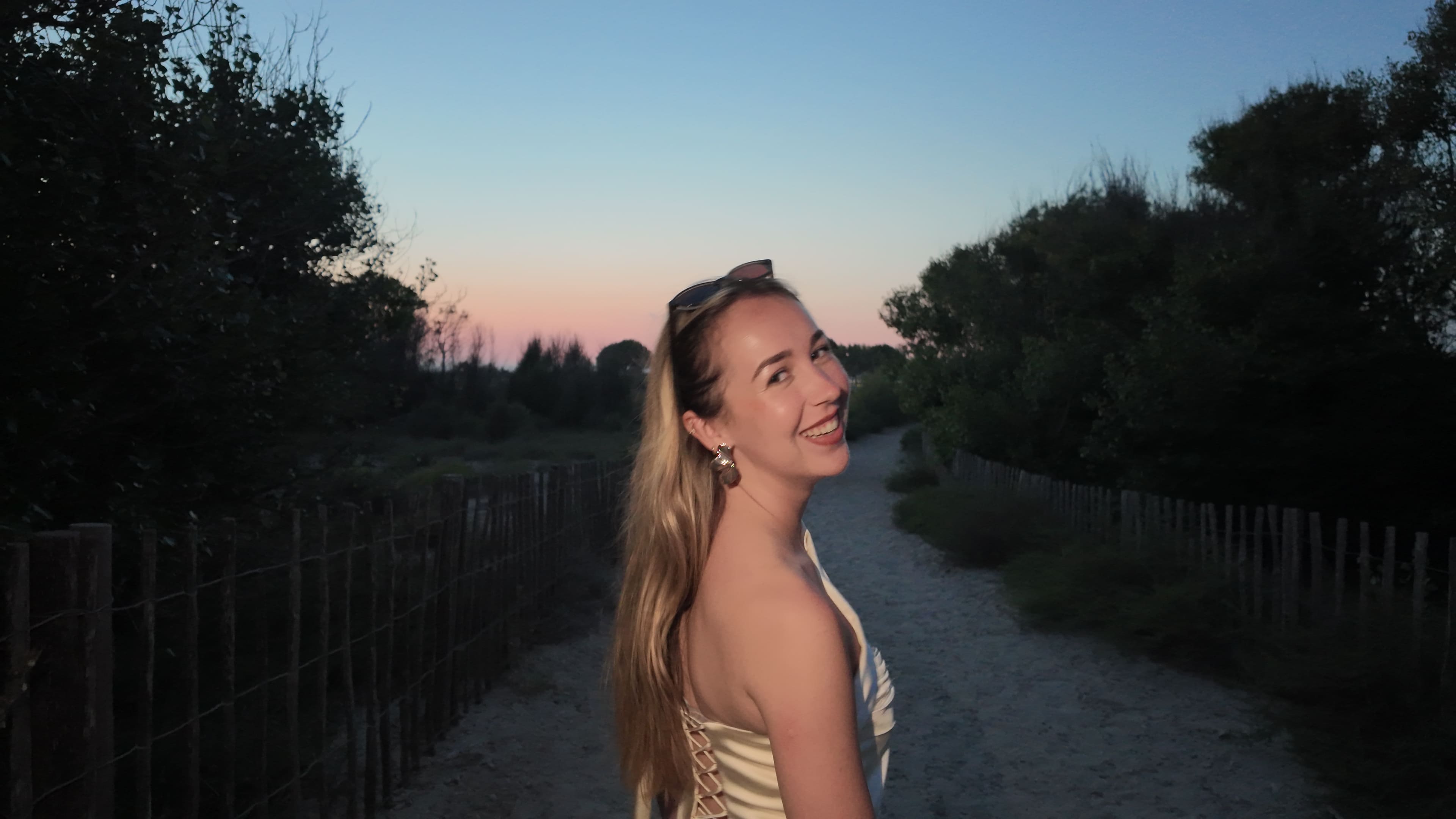 Léa Clavaguéra working on brand design at a modern desk with design tools, color swatches, and digital devices in a bright creative studio